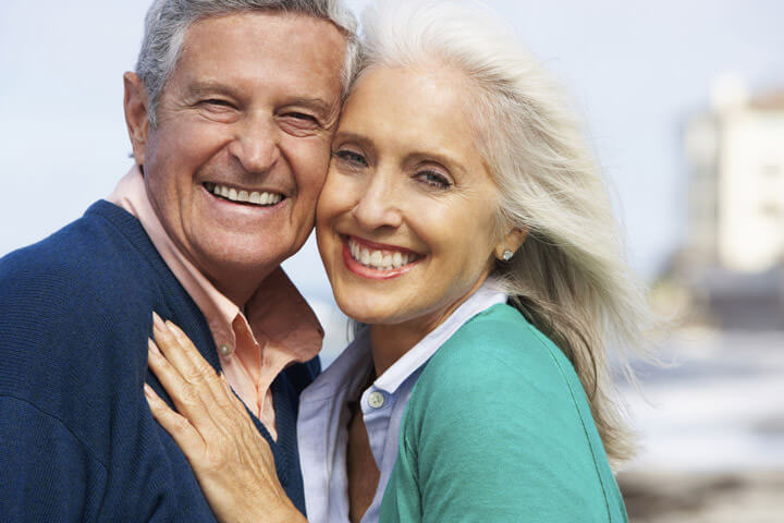 Romantic Senior Couple Hugging On Beach