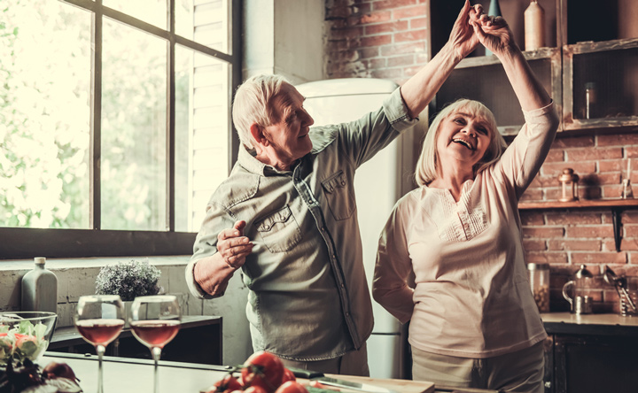 Over 70 dating senior couple is dancing and smiling 